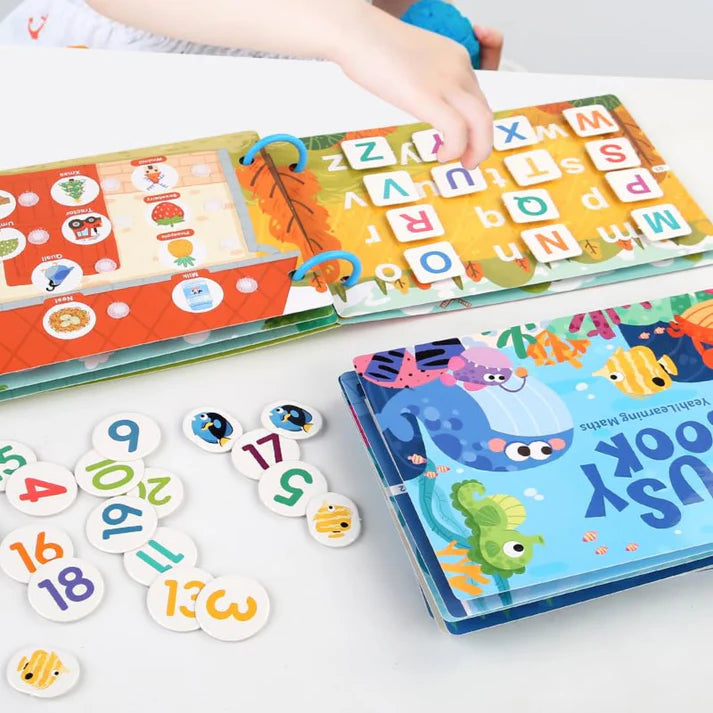 Educational children's books and number cards on a white surface, found in wonder box
